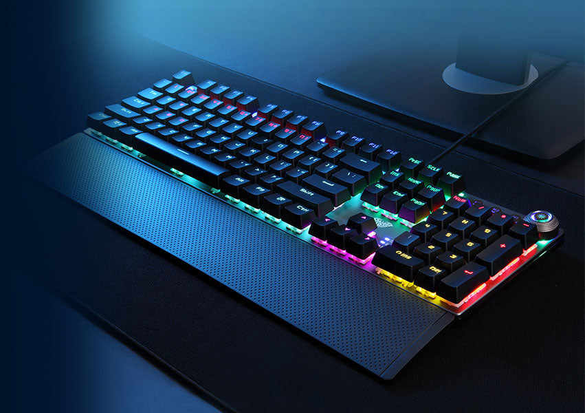 High-performance black mechanical gaming keyboard featuring a wrist rest, bright RGB backlighting, and a dedicated volume control knob.